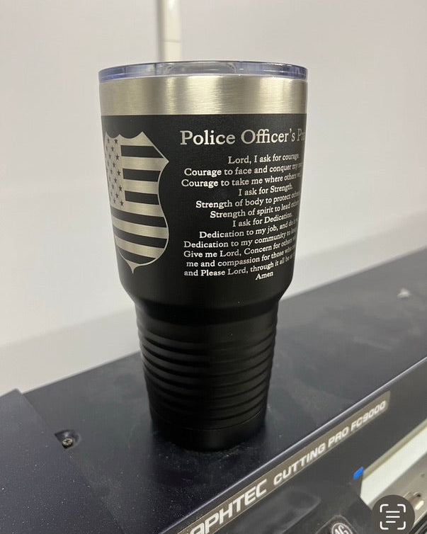 Black tumbler with engraved text on a white background